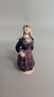 a figurine of a woman in a purple dress