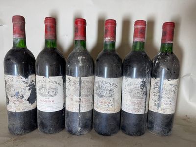 six bottles of wine are lined up in a row on a counter