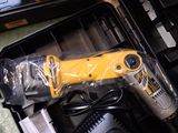 a yellow drill in a black case on a table