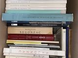 a box full of books that are stacked on top of each other