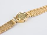 an image of a close up of a wrist watch on a white surface