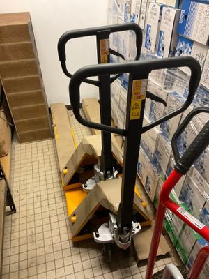 a hand truck that is parked in a warehouse