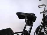 a black motorcycle with a black seat and a black bag