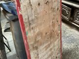 a red door in the middle of a room