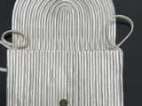 a close up of a white purse with a rope around it