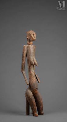 a statue of a woman sitting on top of a wooden block