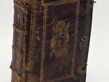 an old book with a decorative design on the cover