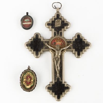 an image of a cross, a medal, and a medal on a white surface