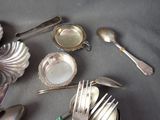 a table with silverware and silver spoons on it
