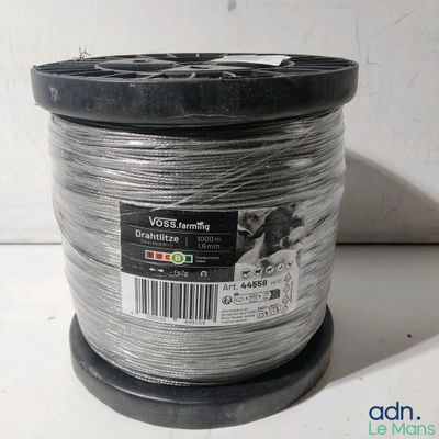a close up of a spool of wire on a white surface
