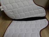 a white chair cushion with a brown trim on it
