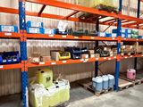 many shelves with various items on them in a warehouse