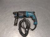 a cord that is connected to a drill on the floor
