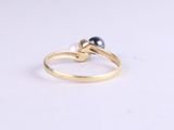 a close up of a gold ring with a pearl on it