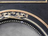 a picture of a black and gold frame with a picture on it