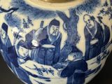 a blue and white vase with a lid on a table