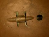 an overhead view of a metal object with a hole in the middle
