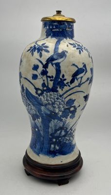a blue and white vase sitting on a wooden stand