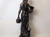 an image of a statue of a woman holding a bucket