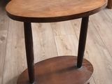 a small wooden table with a shelf on the floor