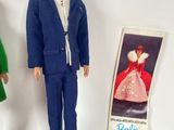 three dolls of a man and a woman standing next to each other