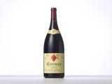 a bottle of red wine sitting on top of a table