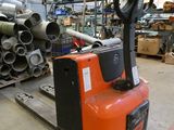 a forklift in a warehouse with lots of pipes and pipes