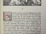 an old book with a picture of a man sitting in a chair