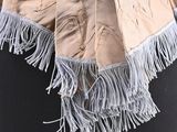 an image of a woman wearing a scarf with fringes on it