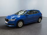 a blue car parked in a room with a white wall