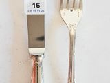 two forks and a knife on a white table
