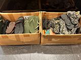 two boxes of shoes that are sitting on the floor