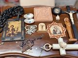 a table with a cross, rosary, and other religious items on it