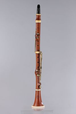 a clarinet with a wooden body and a black top