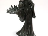 bronze statue of a woman with a hat and robe on a wooden base