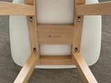 an image of a white chair with wooden legs