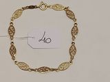 un bracelet en or muni d'une plaque, posé sur une table