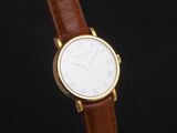 a close up of a watch on a black background