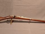 an old rifle with a wooden barrel and a green case