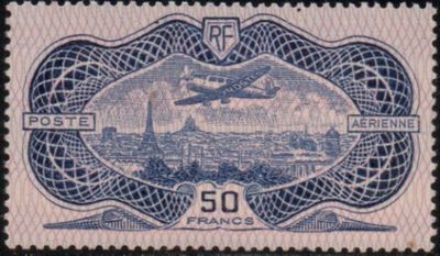 a close up of a stamp with a picture of a plane flying over a city
