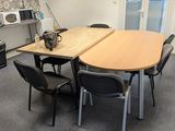a table and chairs in a room with a microwave and a microwave oven