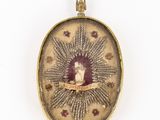 un cadenas ancien en or orné d'une image représentant une femme et un chat
