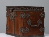 a wooden box with metal handles on a white table