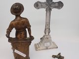 a statue of a woman holding a bucket next to a cross