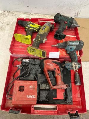 a red tool box with tools in it on the floor