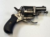 un pistolet posé sur une surface blanche