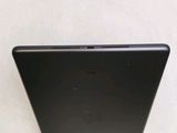 the back of a black laptop computer sitting on top of a table