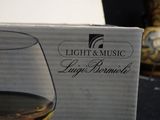 a glass of wine next to a box on a table