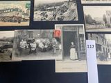 many old photographs of people and buildings on the wall
