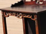 a small wooden table with a mirror on top of it